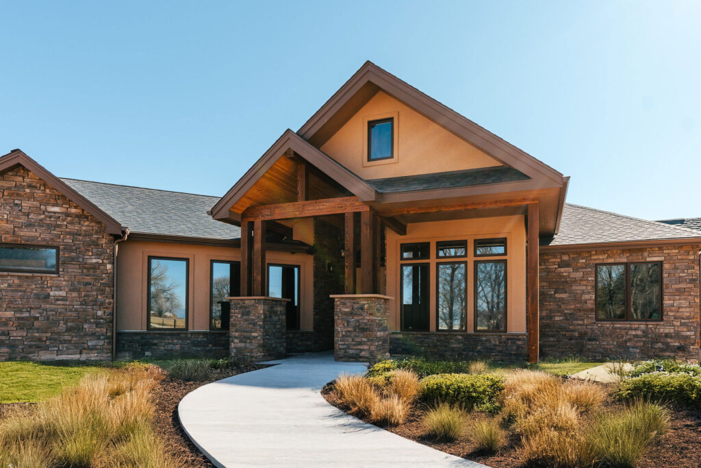 A finished Homestead home, stone and timber entry with a covered porch